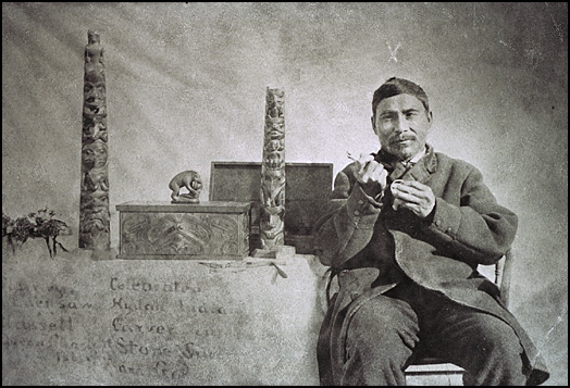 Charles Edenshaw poses with his engraving tool and silver bracelet | Photo by Harlan Ingersoll Smith, 1890/Canadian Museum of Civilization 