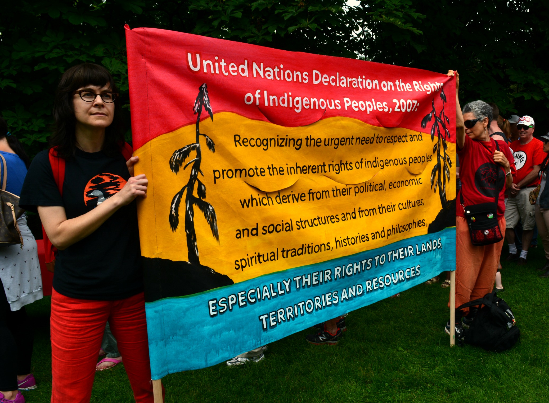 Protesters holding up a sign that explains UNDRIP. Image source: Erica Commanda